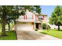 Attractive home featuring a blend of vinyl and brick, with an attached garage and landscaped front yard at 5340 Thompson Park Blvd, Indianapolis, IN 46237