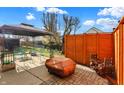 Cozy patio with seating area, fire pit, and wood storage at 5340 Thompson Park Blvd, Indianapolis, IN 46237