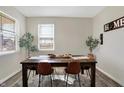 Well-lit dining room featuring a wood table with seating for four and natural light at 5766 Aleppo Ln, Greenwood, IN 46143