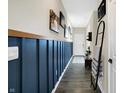 Light-filled entryway with blue wainscoting, hardwood floors, and decorative wall art at 5766 Aleppo Ln, Greenwood, IN 46143