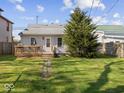 Serene backyard featuring a well-maintained lawn, wooden deck, and mature tree at 619 Fair Ave, Shelbyville, IN 46176