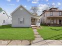 Charming home with a well-maintained lawn, inviting porch and stone walkway, great for curb appeal at 619 Fair Ave, Shelbyville, IN 46176
