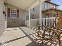Inviting front porch with a porch swing and rocking chair, offering a relaxing outdoor space at 619 Fair Ave, Shelbyville, IN 46176