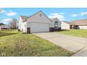 House exterior showcasing a two-car garage and neat lawn at 626 Port Dr, Avon, IN 46123