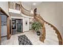Elegant entryway featuring a curved staircase and tile flooring at 7425 Cherryhill Dr, Indianapolis, IN 46254