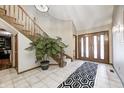 Spacious entry with curved staircase, tiled floors, and large doors at 7425 Cherryhill Dr, Indianapolis, IN 46254