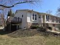 Exterior view of the home highlighting the deck and landscaped yard at 7629 Farm View W Cir, Indianapolis, IN 46256