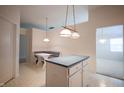 Eat-in kitchen with island, white cabinets, and tiled floor at 11520 Coastal Way, Indianapolis, IN 46229