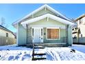 Green house with snow covered yard at 1218 N Ewing St, Indianapolis, IN 46201