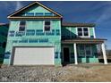 Two story home featuring an attached two car garage under construction with a porch and white support beams at 1350 Foxtail Ln, Greenwood, IN 46143