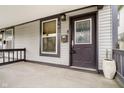 Dark gray front door with glass accents and a welcoming porch at 1421 E New York St, Indianapolis, IN 46201