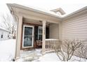 Cozy covered porch with seating, inviting entryway to the home at 15428 Wandering Way, Noblesville, IN 46060