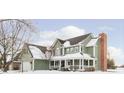 Two-story house with a green exterior, white trim, and a covered porch at 18641 Wychwood Pl, Noblesville, IN 46062