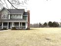 Well-maintained two-story home with a covered front porch and spacious lawn at 18641 Wychwood Pl, Noblesville, IN 46062