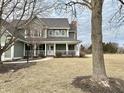 Beautiful two-story home featuring a covered front porch and large yard at 18641 Wychwood Pl, Noblesville, IN 46062