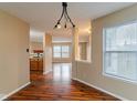Open concept dining area with hardwood floors and view into the living room and kitchen at 2716 Redland Ln, Indianapolis, IN 46217