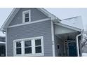 Gray house with white trim, three windows, covered porch; snow on the ground at 34 Iowa St, Indianapolis, IN 46225