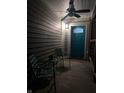 Small front porch with teal door and two chairs at 34 Iowa St, Indianapolis, IN 46225