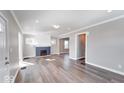 Bright living room featuring hardwood floors, a decorative fireplace, and ample natural light at 4014 N Capitol Ave, Indianapolis, IN 46208