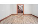 Hardwood floor living room with view into the entryway and staircase at 503 S Harrison St, Alexandria, IN 46001