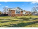 Side view of brick ranch house with a large grassy yard at 5249 Hickory Rd, Indianapolis, IN 46239