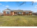 Brick ranch house with a spacious lawn and mature trees at 5249 Hickory Rd, Indianapolis, IN 46239