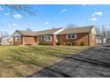 Front view of brick ranch house with a long driveway at 5249 Hickory Rd, Indianapolis, IN 46239