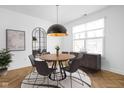 Modern dining room with hardwood floors and a round wooden table at 1003 Alabama St, Indianapolis, IN 46202
