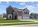 Charming two-story home with a combination brick and siding exterior and well-kept lawn at 1069 Ridgevine Rd, Greenwood, IN 46143
