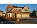 Beautiful two-story brick home with a two-car garage and manicured front yard at 1069 Ridgevine Rd, Greenwood, IN 46143