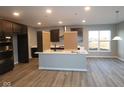 Spacious kitchen with a large center island, stainless steel appliances, and hardwood floors at 1069 Ridgevine Rd, Greenwood, IN 46143