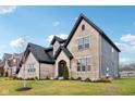 Tan brick home with dark gray accents and a grassy yard at 12458 Palmetto Bay St, Fishers, IN 46037