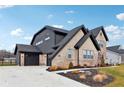 Two-story home with attached garage and a large driveway at 12458 Palmetto Bay St, Fishers, IN 46037