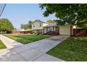 House exterior showcasing a spacious lawn, driveway, and wooden fence at 1801 Witt Rd, Lebanon, IN 46052