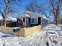 Charming house with a wooden fence, mailbox, and snowy front yard at 2817 S Rybolt Ave, Indianapolis, IN 46241