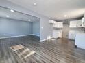 Open concept kitchen and living area with gray walls and wood floors at 2817 S Rybolt Ave, Indianapolis, IN 46241