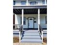 Front porch with gray concrete steps and black railings at 3156 Graceland Ave, Indianapolis, IN 46208