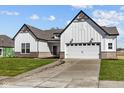 Charming home with white siding, a two-car garage, and a well-kept lawn on a sunny day at 4068 Berry Chase Blvd, Greenwood, IN 46143
