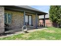 Comfortable covered back porch features brick columns and offers a relaxing outdoor space at 7709 Santolina Dr, Indianapolis, IN 46237