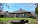 Expansive backyard with brick patio and lush lawn perfect for outdoor entertaining and relaxation at 7709 Santolina Dr, Indianapolis, IN 46237