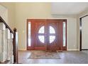 Elegant entryway with double doors, featuring a circular glass design and tile flooring at 105 S Maxwell Ct, Zionsville, IN 46077