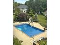 Inviting backyard pool with a slide, basketball hoop, and plenty of green space at 105 S Maxwell Ct, Zionsville, IN 46077