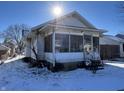 White house with screened porch and snowy yard at 1717 W 11Th St, Muncie, IN 47302