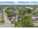 Neighborhood aerial view, displaying residential homes and streets surrounded by mature trees in the community at 1819 Southeastern Ave, Indianapolis, IN 46201