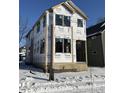 New construction home exterior; two-story home, covered porch, winter scene at 2021 Cornell Ave, Indianapolis, IN 46202