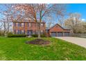 Charming two-story brick home with blue shutters and a three-car garage at 20485 Country Pine Ct, Noblesville, IN 46062