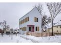 Modern two-story house with light grey siding, tan accents and pink door, snowy yard at 220 N Beville Ave, Indianapolis, IN 46201