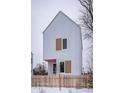 Modern two-story house with light grey siding, tan accents, snowy yard, and wooden fence at 220 N Beville Ave, Indianapolis, IN 46201