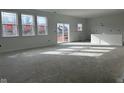 Spacious living room with large windows and sliding glass doors at 241 Ames Dr, Whiteland, IN 46184