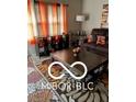Living room with a brown couch, coffee table, and patterned rug at 2714 Baltimore Ave, Indianapolis, IN 46218